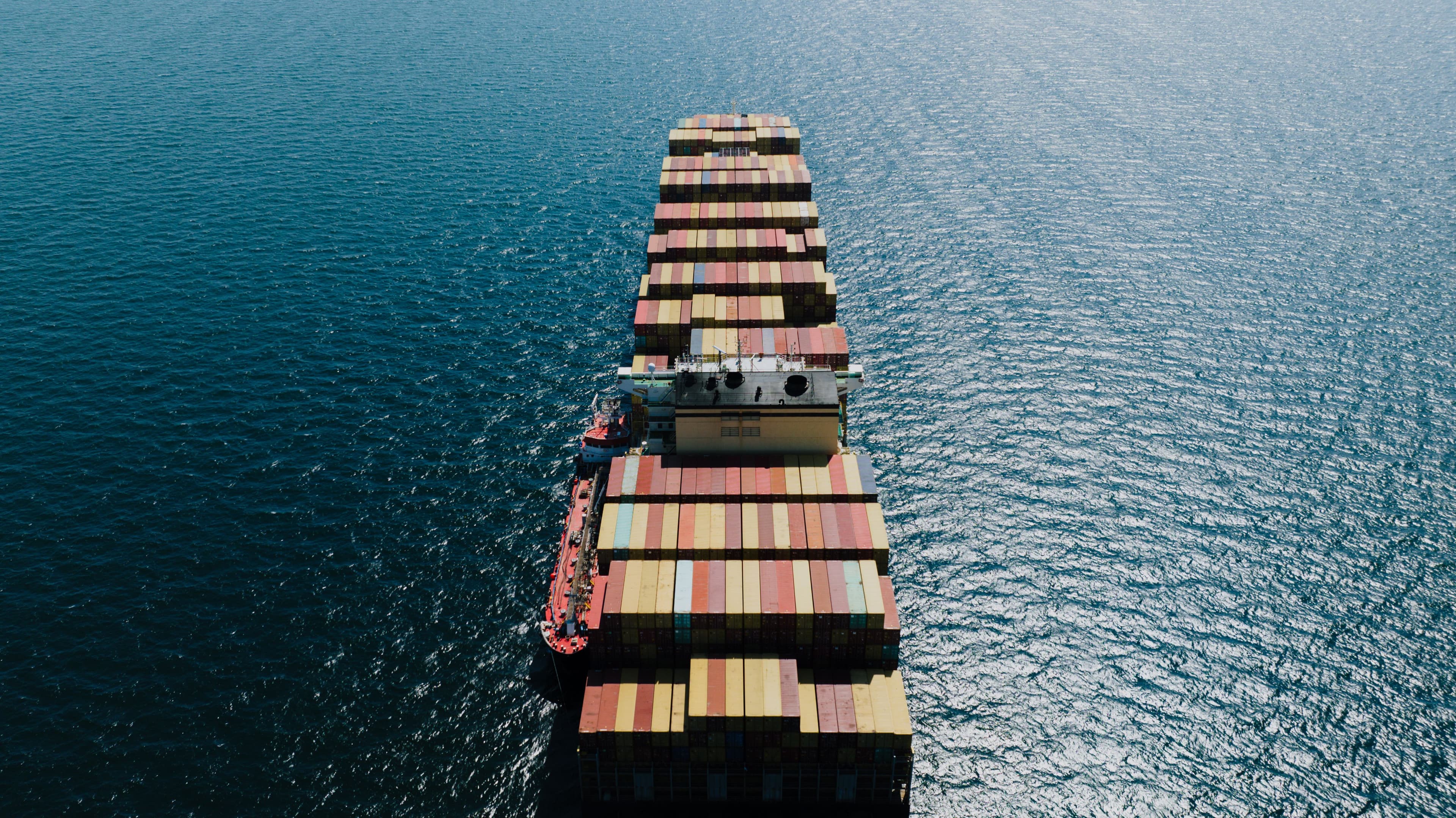 Aerial view of a fully laden container ship crossing open sea
